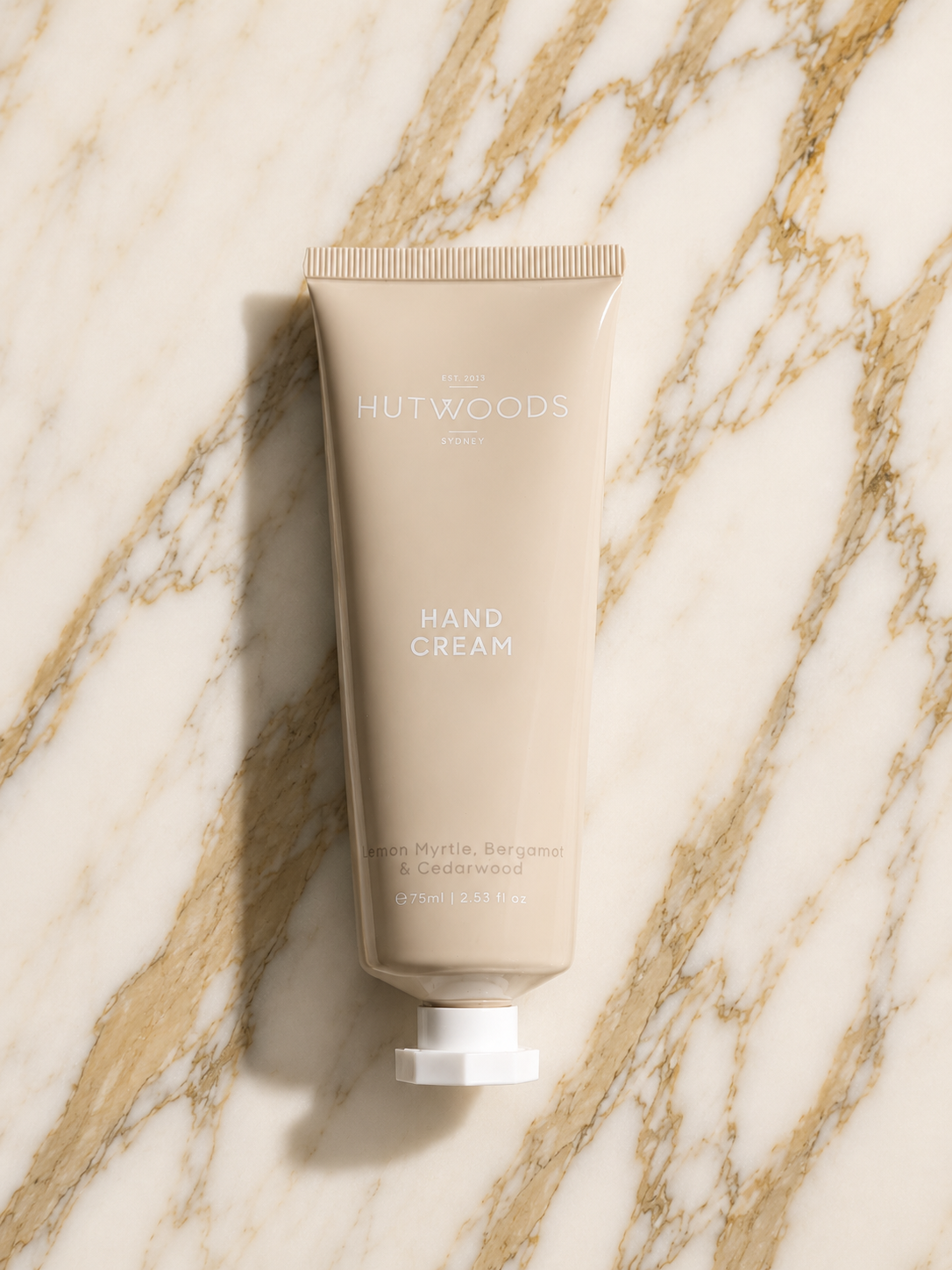 Tube of Hutwoods hand cream on a marble surface