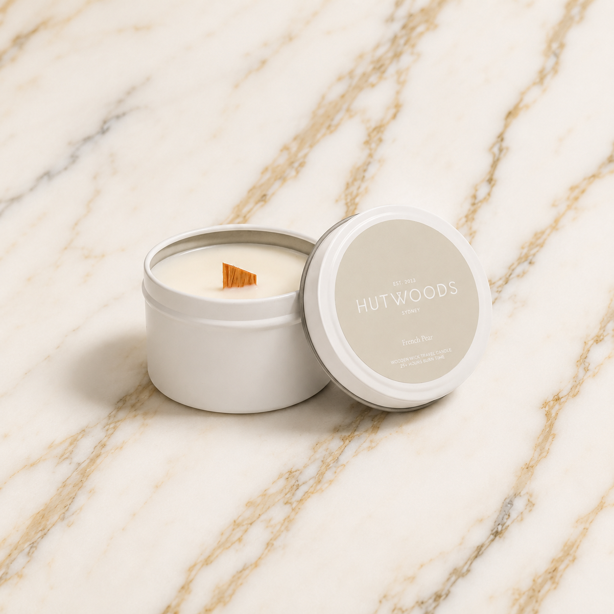 Hutwoods candle in a tin with lid on a marble surface