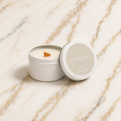 Hutwoods candle in a tin with lid on a marble surface