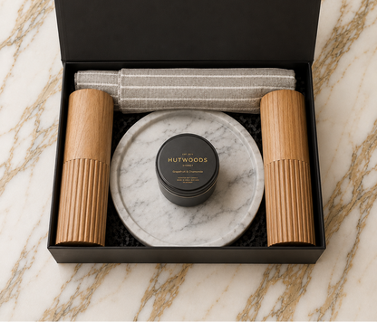 Hamper with cotton apron, salt and pepper mills, a catch all marble tray and hutwoods travel candle 