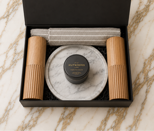 Hamper with cotton apron, salt and pepper mills, a catch all marble tray and hutwoods travel candle 